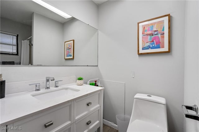 bathroom featuring vanity and toilet