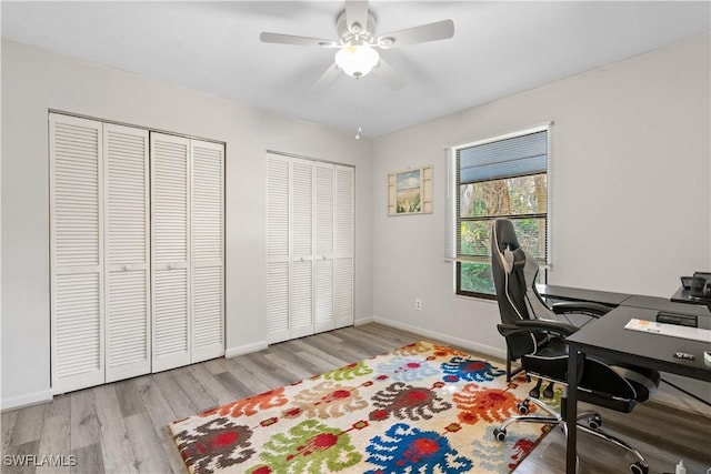 office with ceiling fan and light hardwood / wood-style floors