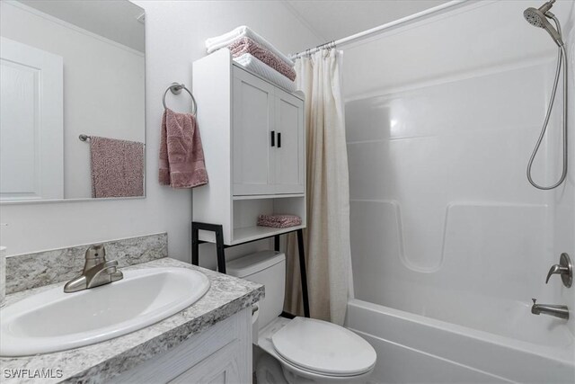 full bathroom featuring shower / bath combo, vanity, and toilet