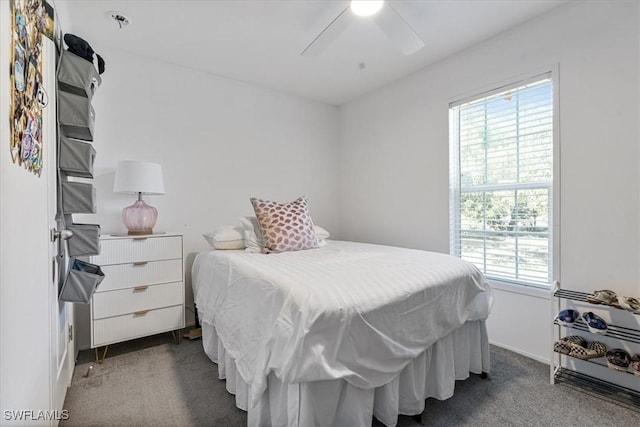 bedroom with ceiling fan and dark carpet