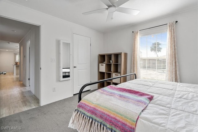 bedroom featuring crown molding, carpet flooring, and ceiling fan