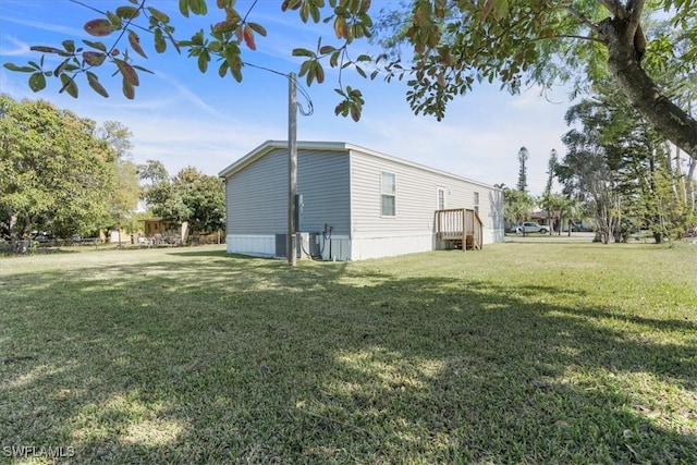 view of side of home featuring a lawn