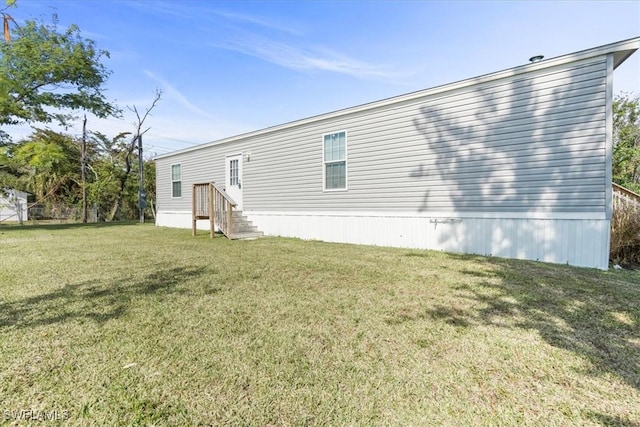 rear view of property with a lawn