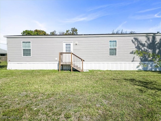 back of property featuring a lawn