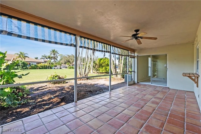 unfurnished sunroom with ceiling fan