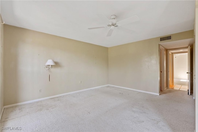 spare room featuring ceiling fan and light carpet