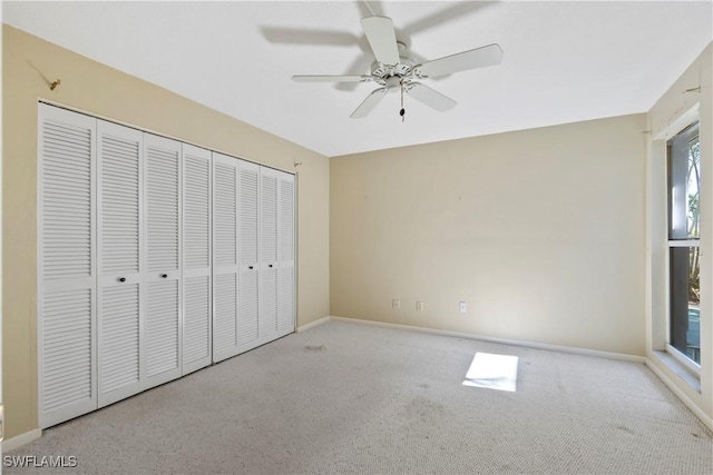 unfurnished bedroom with light carpet, ceiling fan, and a closet