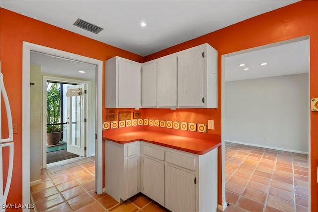 kitchen featuring white cabinetry and light tile patterned floors