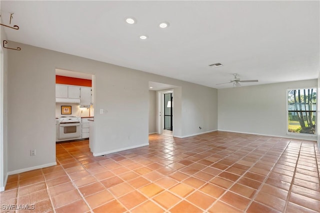 tiled empty room with ceiling fan