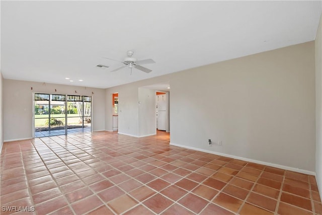 spare room featuring ceiling fan and light tile patterned floors