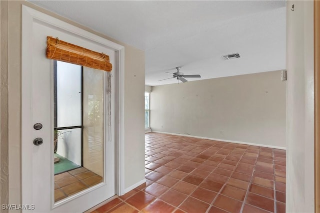 spare room with tile patterned floors and ceiling fan