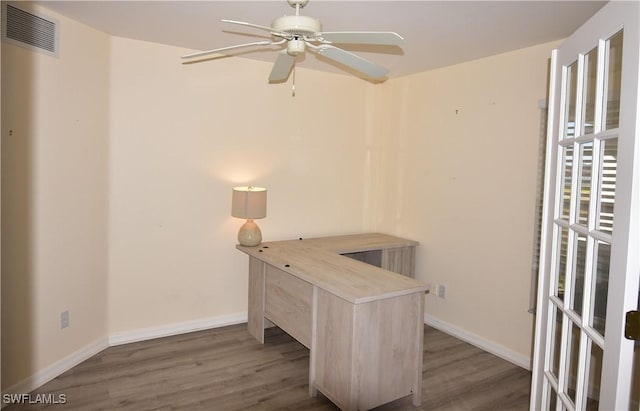 home office with dark hardwood / wood-style floors and ceiling fan