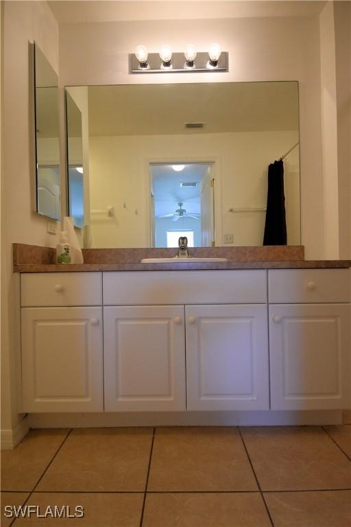 bathroom with vanity, tile patterned floors, and walk in shower