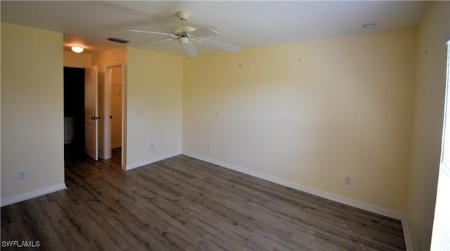 empty room with dark wood-type flooring and ceiling fan