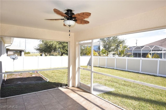 unfurnished sunroom with plenty of natural light and ceiling fan