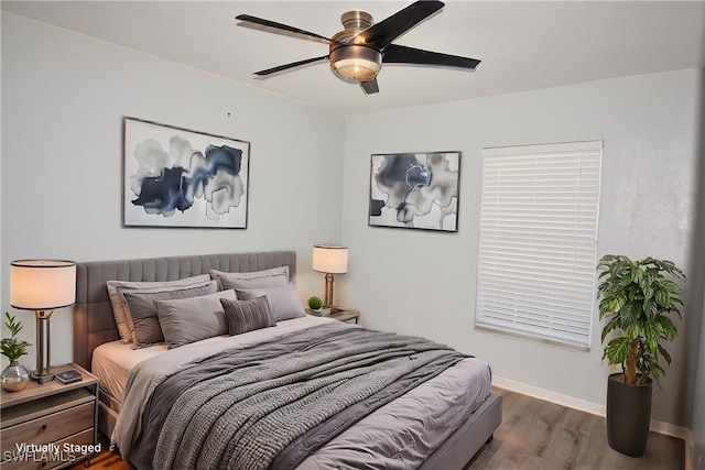 bedroom featuring ceiling fan and dark hardwood / wood-style flooring