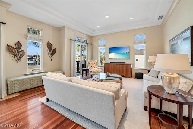 living room featuring ornamental molding and wood-type flooring