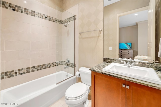 full bathroom featuring tiled shower / bath, vanity, and toilet