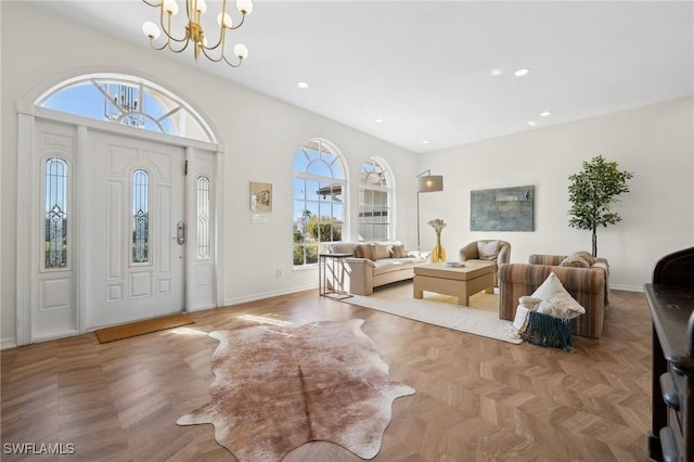 foyer entrance featuring parquet flooring and a notable chandelier