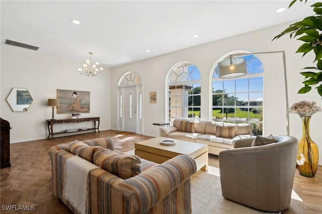 living room with parquet floors and a notable chandelier