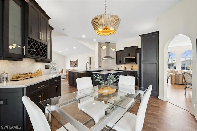 dining space with wet bar and dark hardwood / wood-style floors