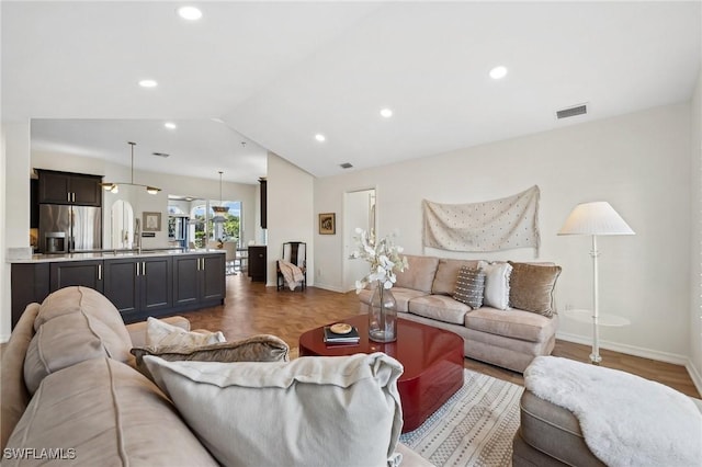 living room with lofted ceiling and dark parquet floors