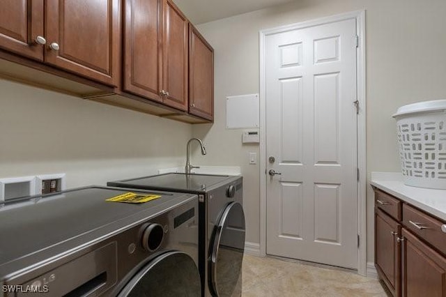 washroom featuring cabinets and washer and dryer