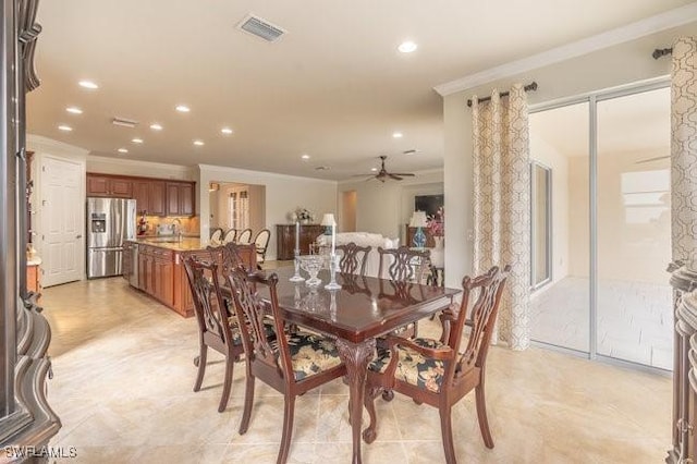 dining space featuring ceiling fan and ornamental molding