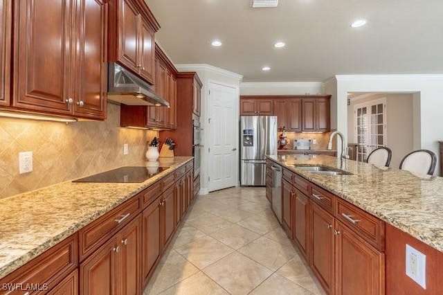 kitchen featuring sink, light stone counters, ornamental molding, appliances with stainless steel finishes, and backsplash