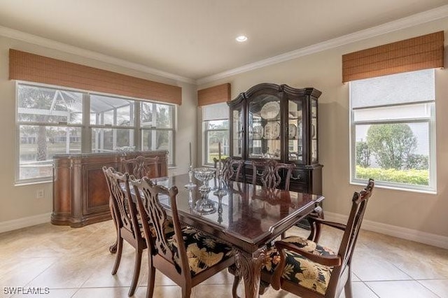 dining room featuring crown molding and light tile patterned flooring