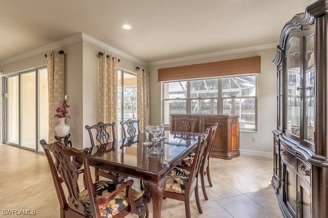 dining room featuring crown molding and light tile patterned floors