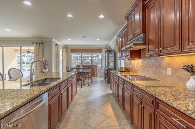 kitchen with light stone counters, stainless steel dishwasher, black electric stovetop, and sink