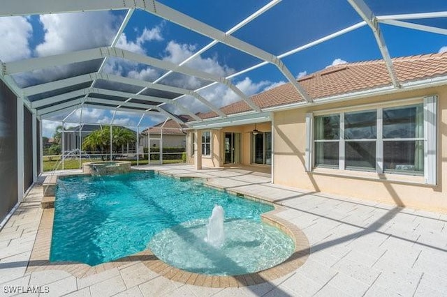 view of pool featuring a patio, pool water feature, and glass enclosure