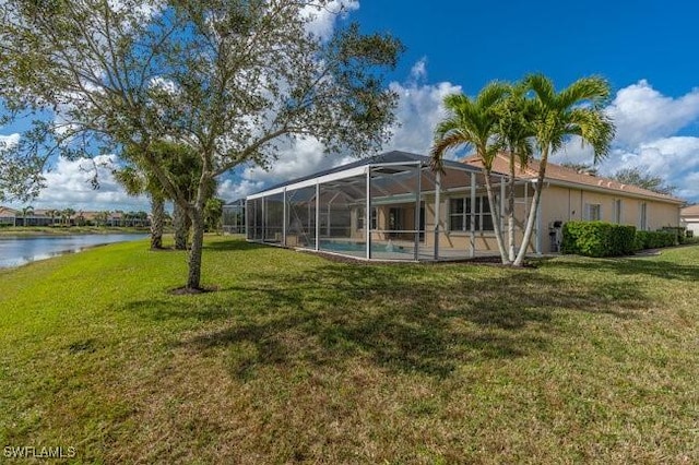 view of yard featuring a water view and glass enclosure