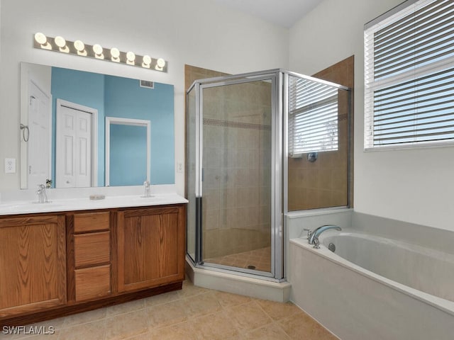 bathroom featuring tile patterned floors, shower with separate bathtub, and vanity