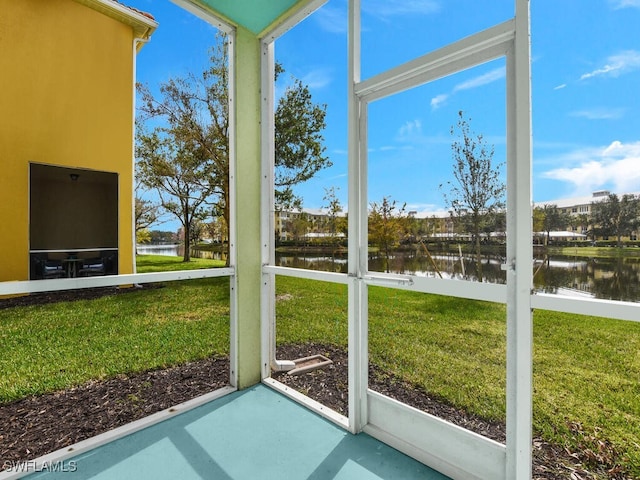 unfurnished sunroom with a water view