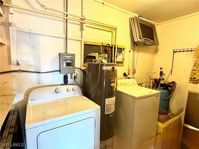 clothes washing area featuring water heater and hookup for an electric dryer