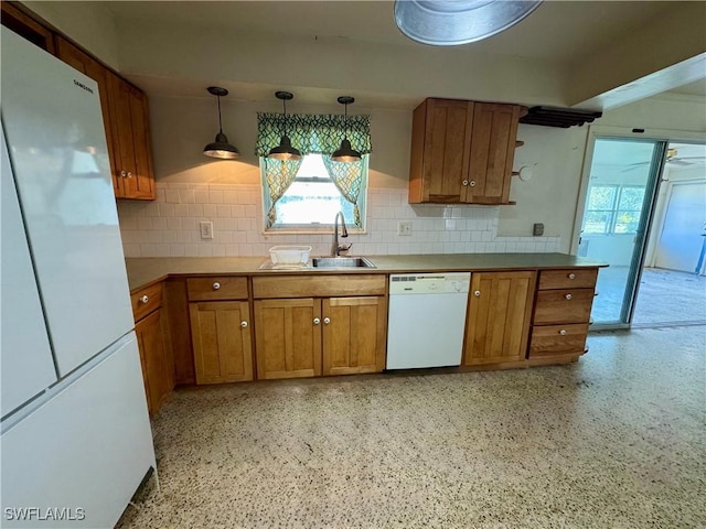 kitchen with sink, pendant lighting, white appliances, and decorative backsplash