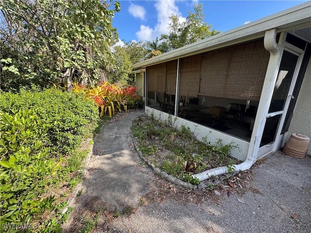 view of side of property featuring a sunroom