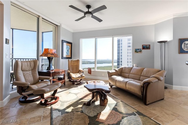 living room with a water view, ceiling fan, and crown molding