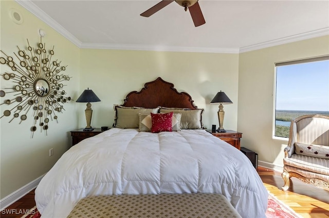 bedroom with hardwood / wood-style floors, crown molding, and ceiling fan