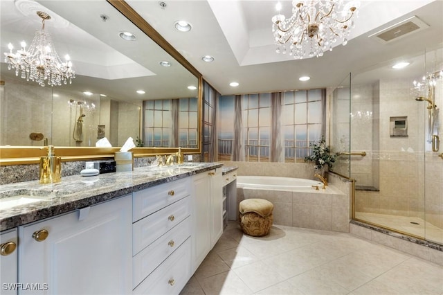 bathroom with independent shower and bath, vanity, a raised ceiling, tile patterned floors, and an inviting chandelier