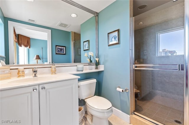 bathroom with vanity, toilet, and an enclosed shower