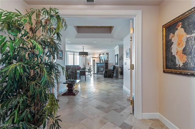 hallway with a tray ceiling