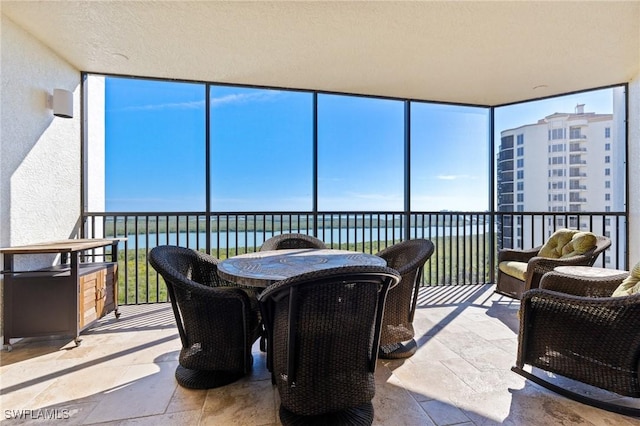 sunroom / solarium with a water view