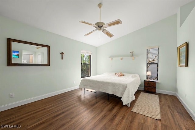 bedroom featuring lofted ceiling, dark hardwood / wood-style flooring, and ceiling fan