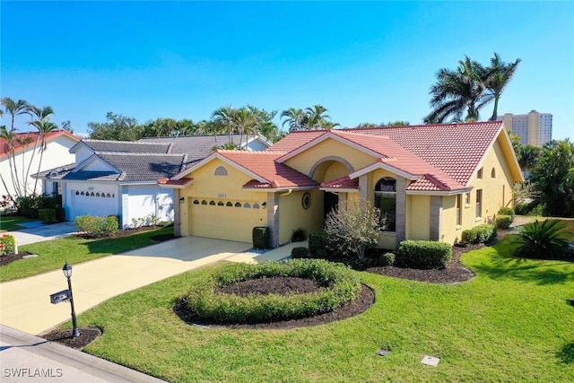 mediterranean / spanish home with a garage and a front yard