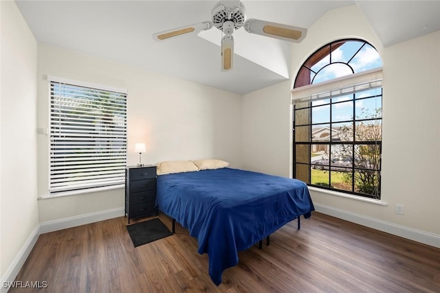 bedroom featuring dark wood-type flooring, ceiling fan, and vaulted ceiling