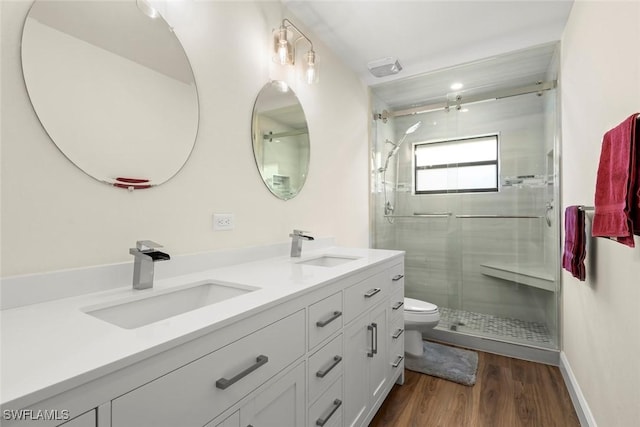 bathroom featuring vanity, an enclosed shower, hardwood / wood-style flooring, and toilet