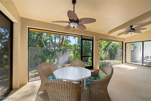 sunroom / solarium with lofted ceiling and ceiling fan